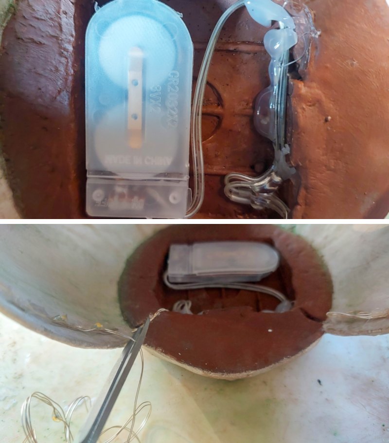 Glue the fairy light battery pack to the floor of the art studio
