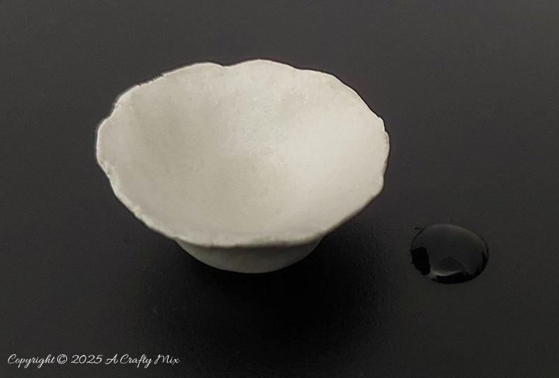 A small clay bowl baked in an air-fryer with a water droplet