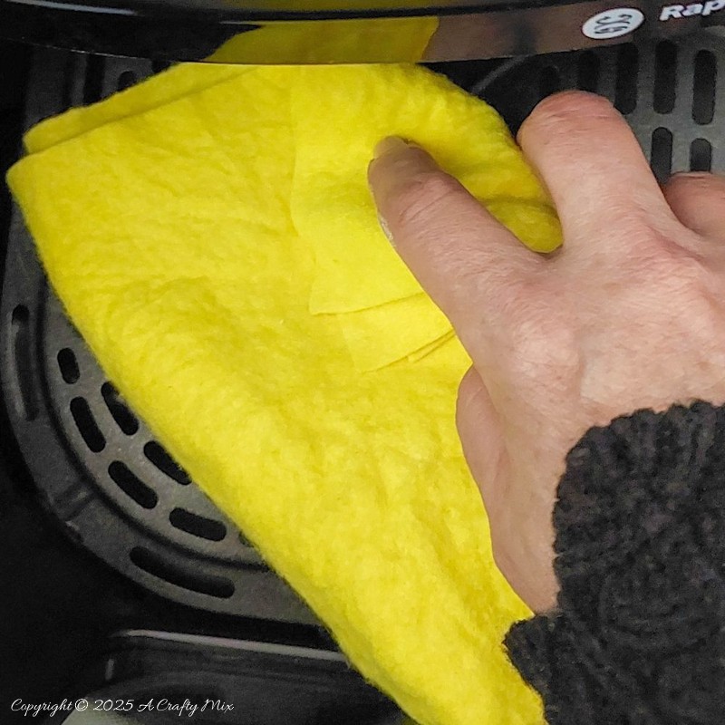Wiping and cleaning the air fryer after baking my air-dry clay