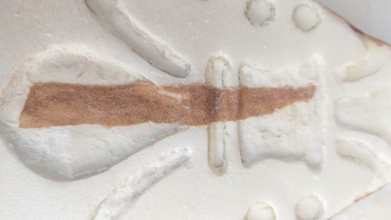 Glue the brown paper strips over the "carved" Christmas trees