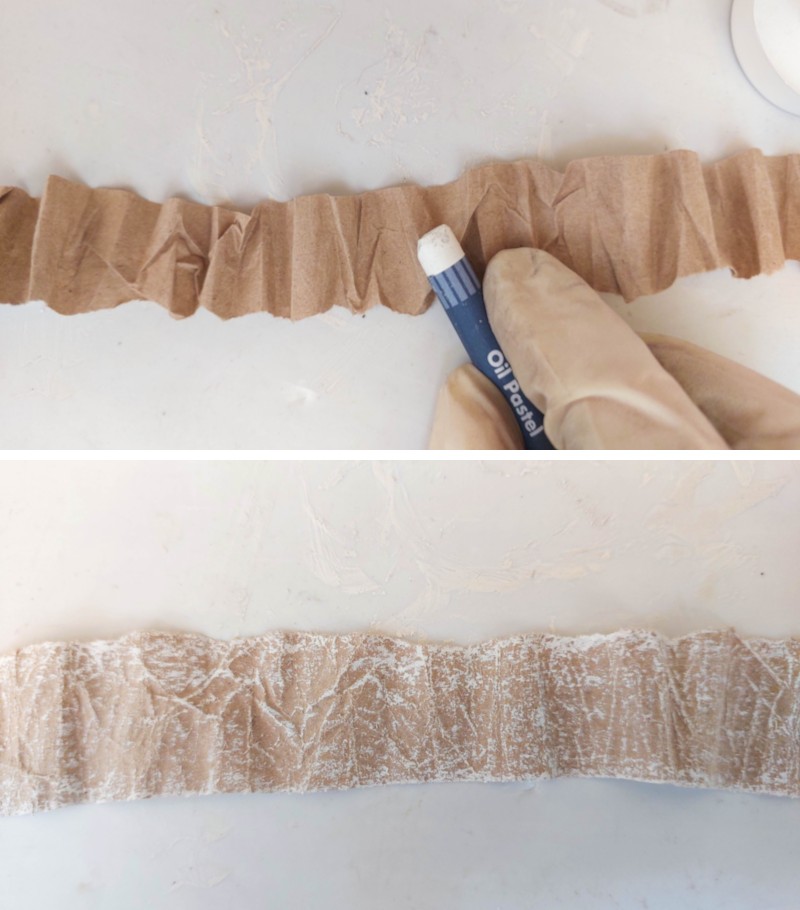 Distress the brown paper with white pastels