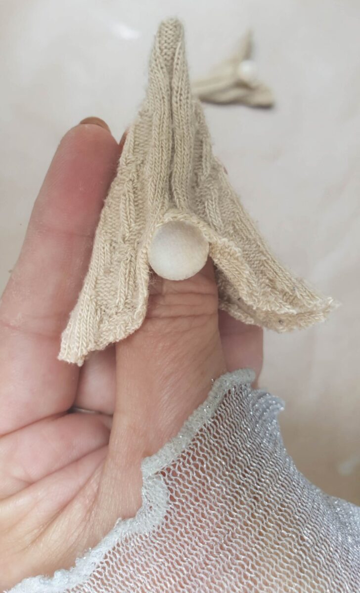 Glue a bead or clay ball onto the hat to make a nose
