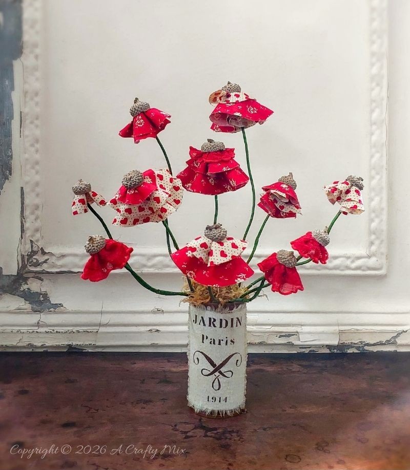 These easy, no-sew acorn cap flowers are the perfect way to use up scrap fabric and create long‑lasting handmade blooms. Arrange them in vases, cluster them into rustic centerpieces, or nestle them into wreaths and gifts for a storybook touch.