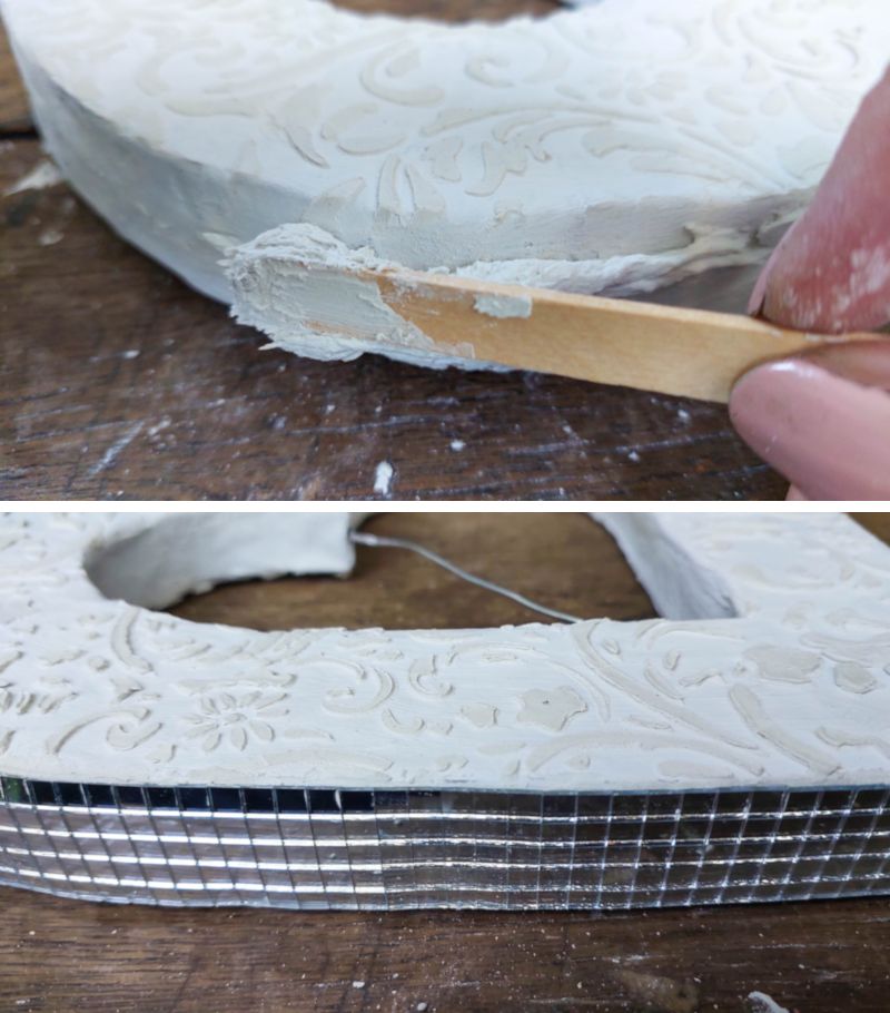 Glue mirror tiles along the outer edge of the cardboard hearts