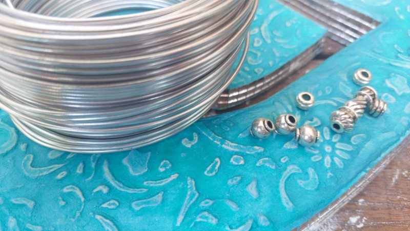 To hang the wind spinner use 9 gauge wire and beads