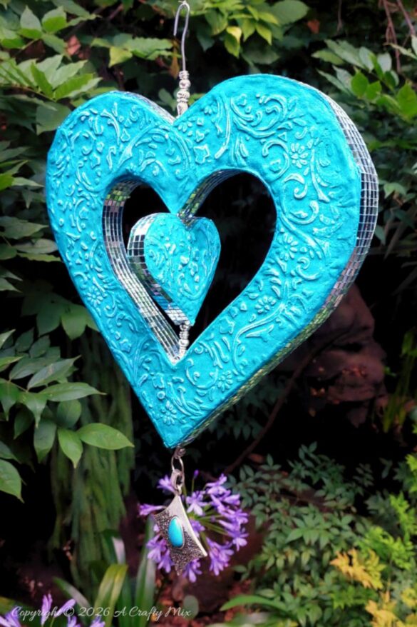 Create your own cardboard heart wind spinner with this beginner-friendly tutorial that walks you through cutting, shaping, embossing, and finishing a colorful hanging heart for dreamy patio décor.