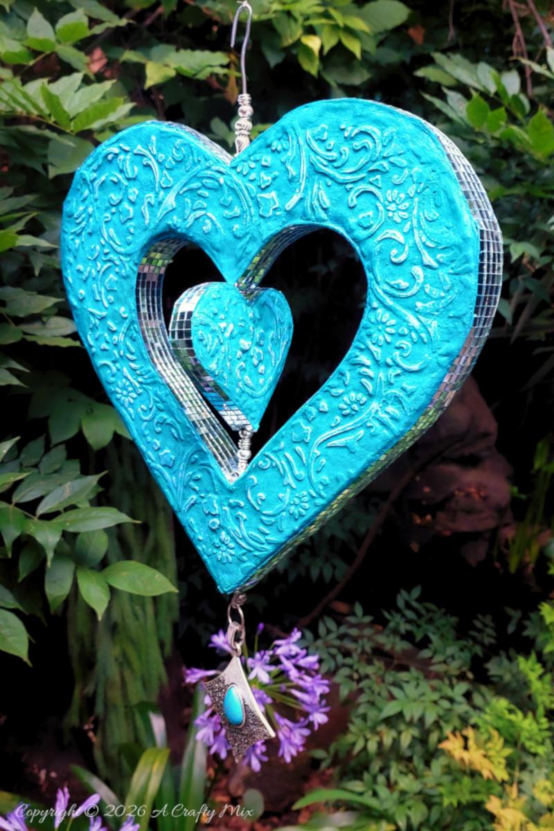 Create your own cardboard heart wind spinner with this beginner-friendly tutorial that walks you through cutting, shaping, embossing, and finishing a colorful hanging heart for dreamy patio d&eacute;cor.
