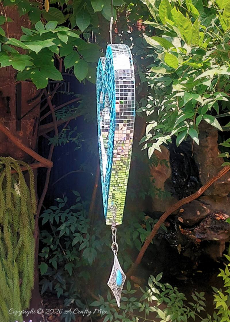 Create your own cardboard heart wind spinner with this beginner-friendly tutorial that walks you through cutting, shaping, embossing, and finishing a colorful hanging heart for dreamy patio d&eacute;cor.