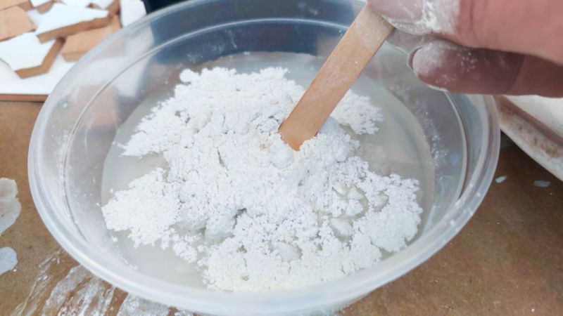 Always add the dry concrete and tile adhesive to water to minimize dust