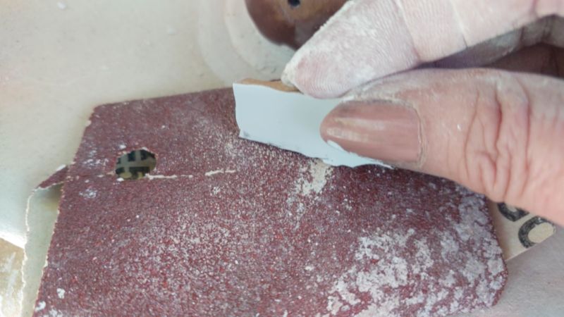 Sand the edges of a the tiles if the cuts are jagged