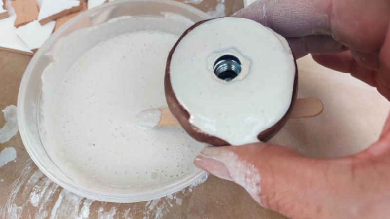 Add a good dollop of the tile adhesive to the clay center