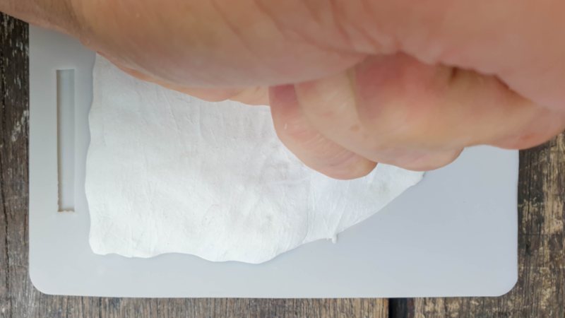 Flatten the clay into the mold