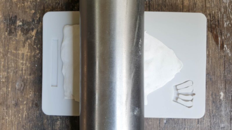 Roll the clay into the mold to flatten it out