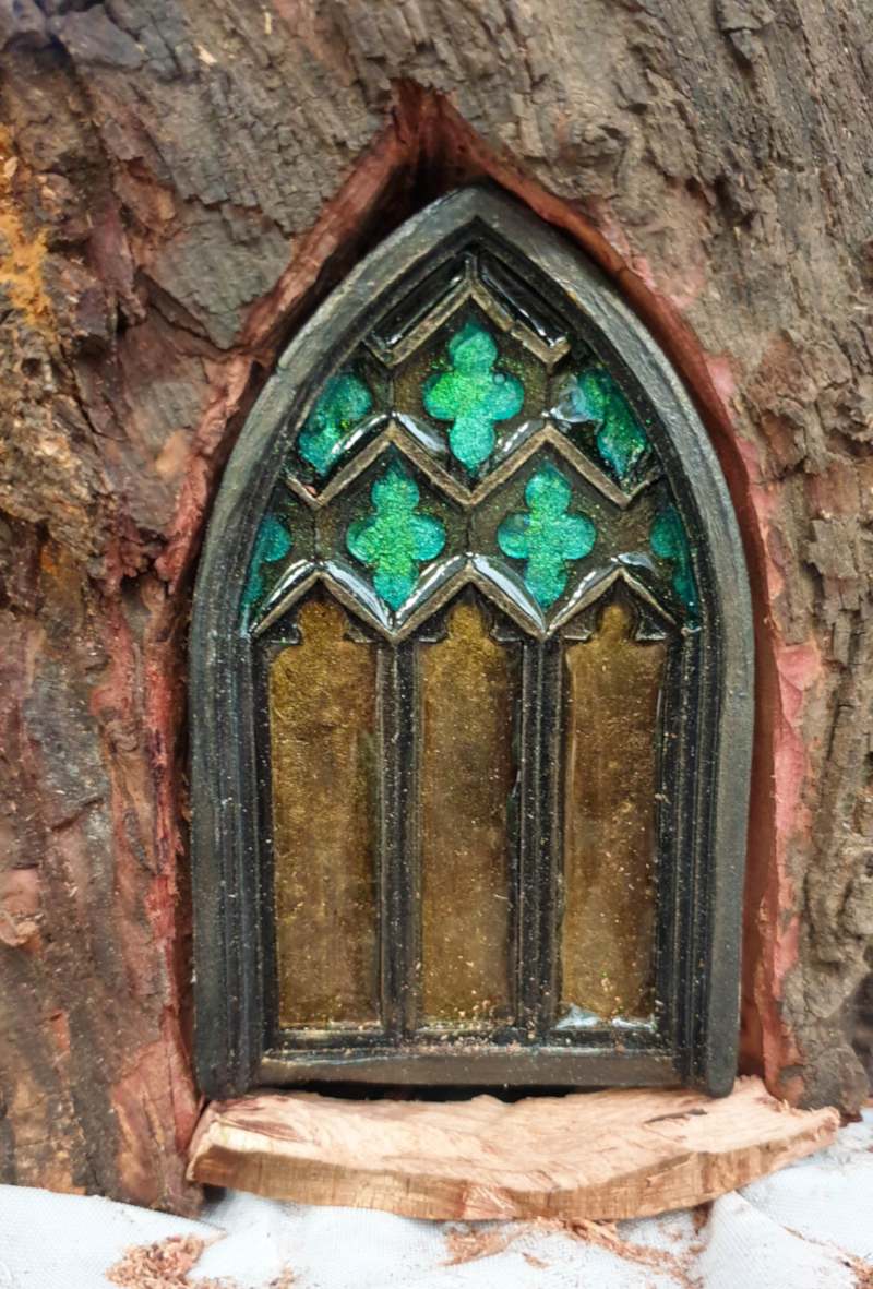 Test fitting the fairy door in the tree stump