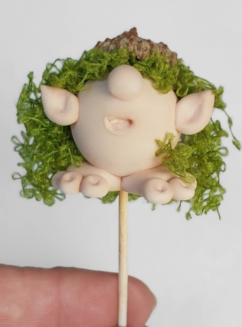 Glue the hair and acorn cap on