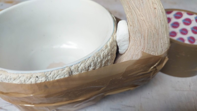 Tape the mushroom stalk to the mug