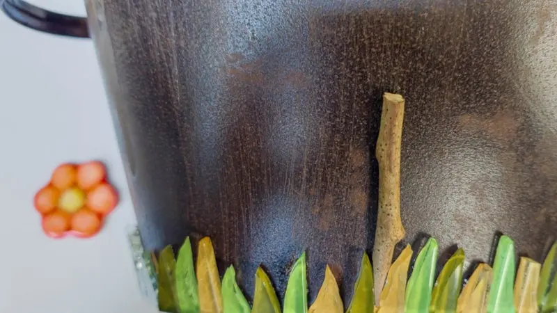 Glue the twigs in between the tiles