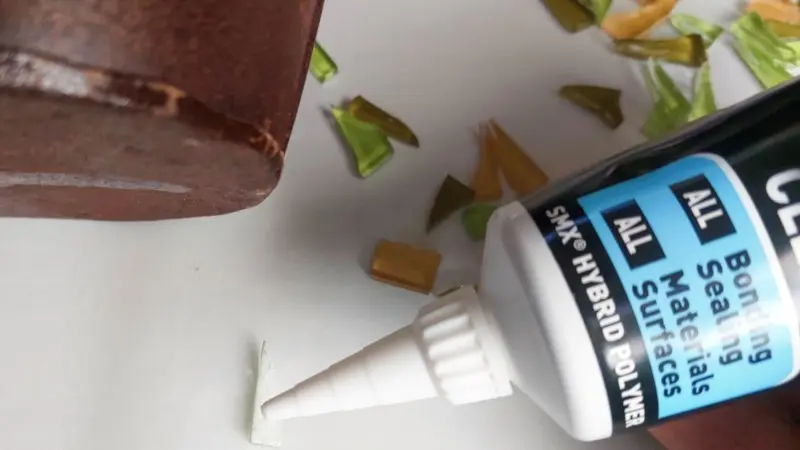 Glue the tiles around the base of the planter