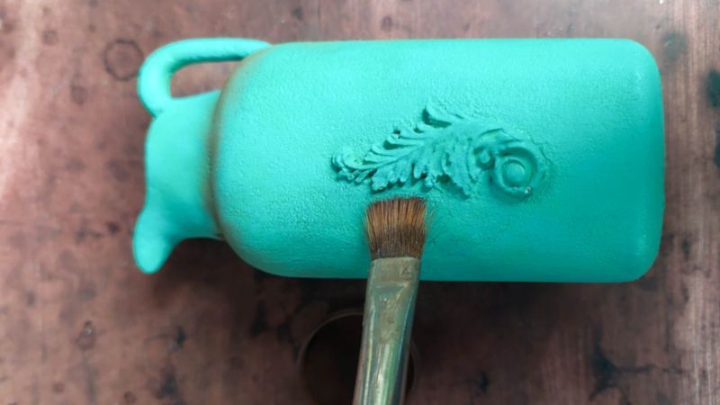 Painting the baby powder bottle vase turquoise.
