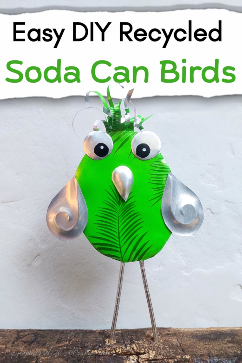 Close up of a bright green DIY, recycled Soda Can Bird made from an aluminium drink can with large eyes and embossed metal wings.