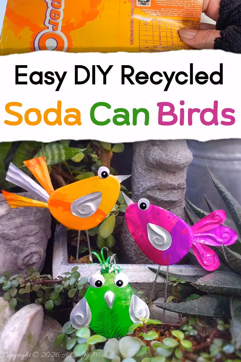 Orange, pink and green recycled Soda Can Birds on wire legs decorating potted plants in a small garden.
