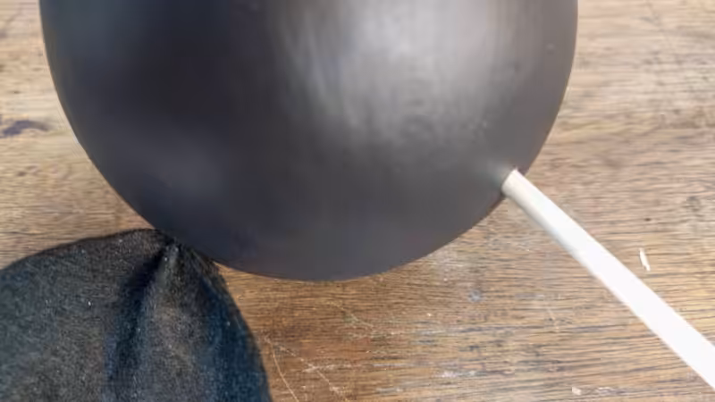 Poke holes on the side of the bat's head and insert the ears