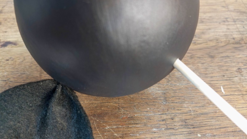 Poke holes on the side of the bat's head and insert the ears