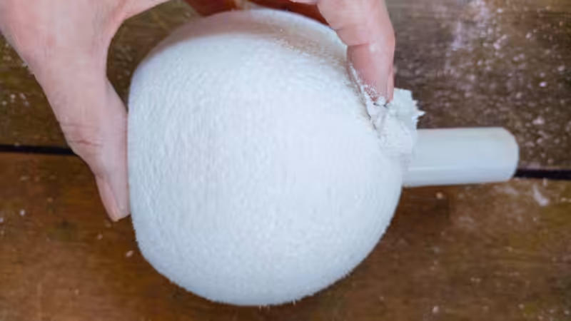 Apply the texture paste all over the upcycled vase