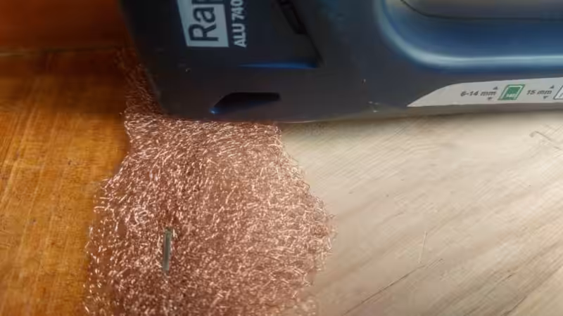 A close up view of a stapler and copper mesh