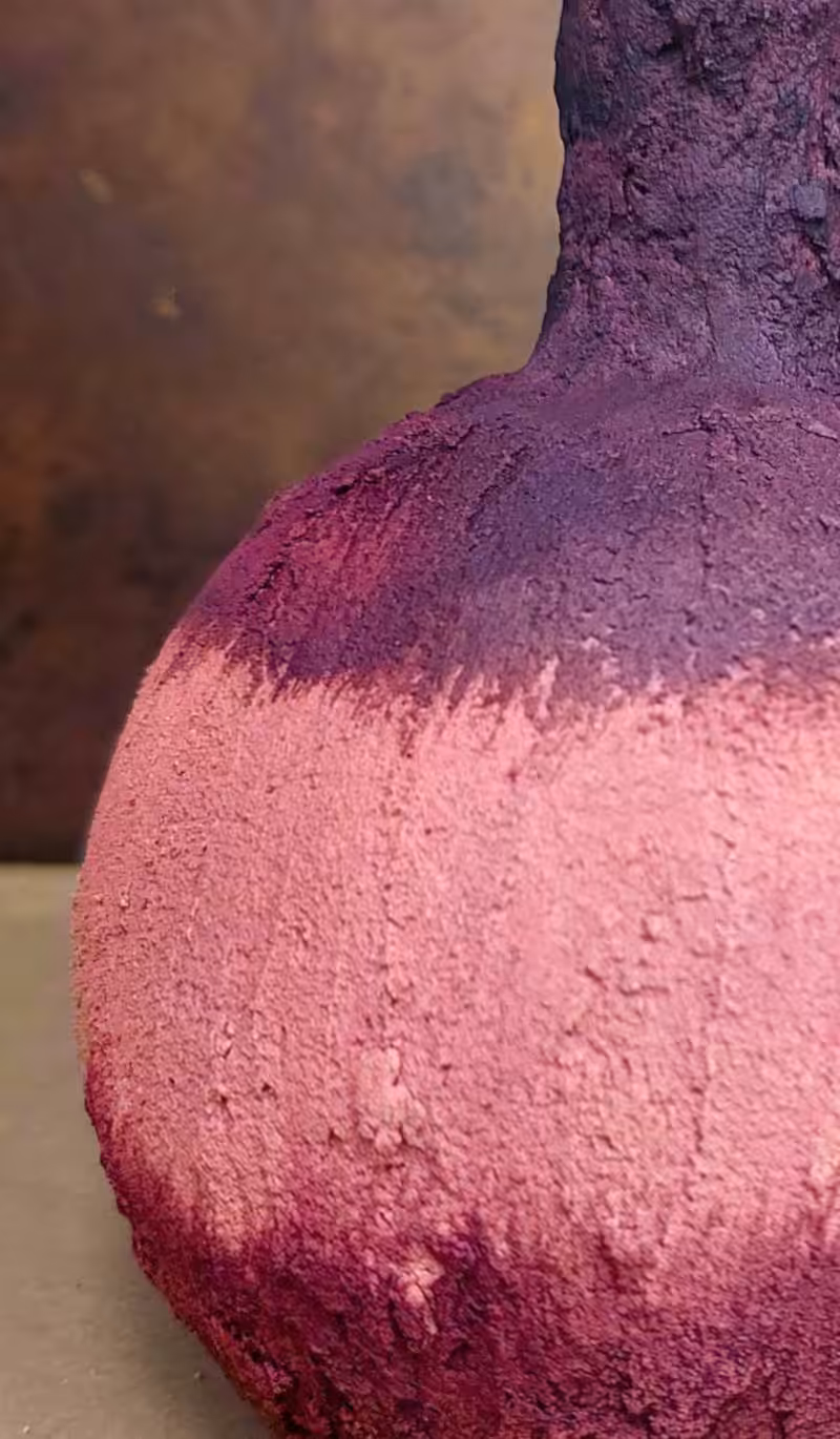A close up of the upcycled vase painted in berry and plum