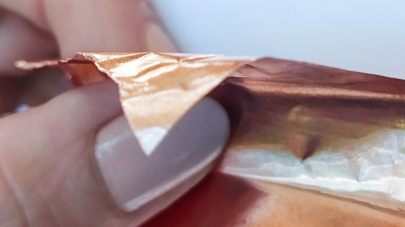 A hand holding copper tape