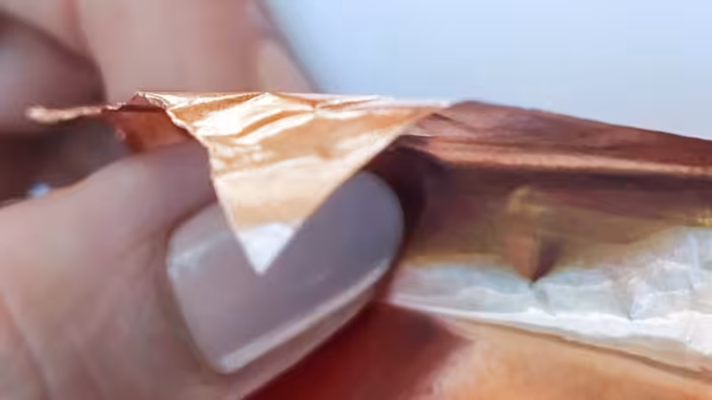 A hand holding copper tape