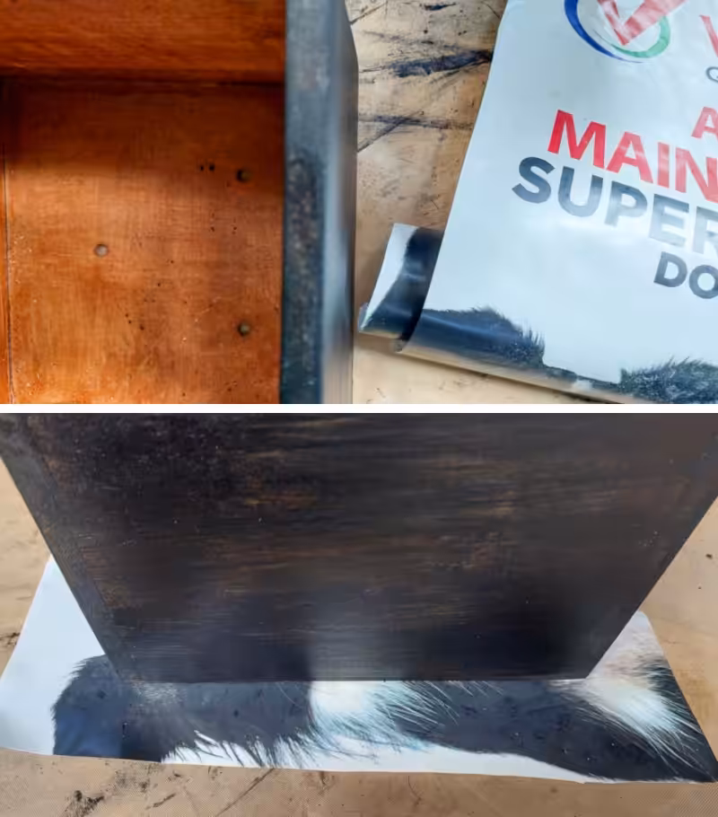 A wooden planter sits next to a plastic bag that will be used as a lining