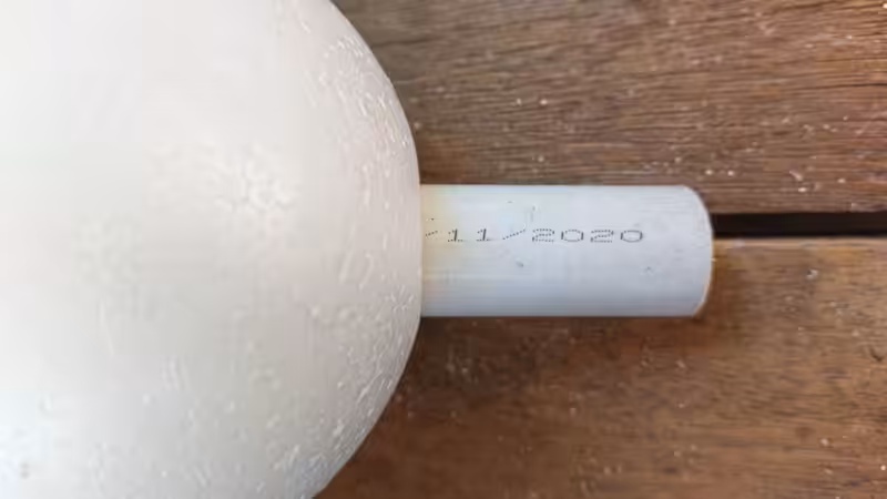 Insert the cut plastic pipe into the polystyrene (Styrofoam) ball