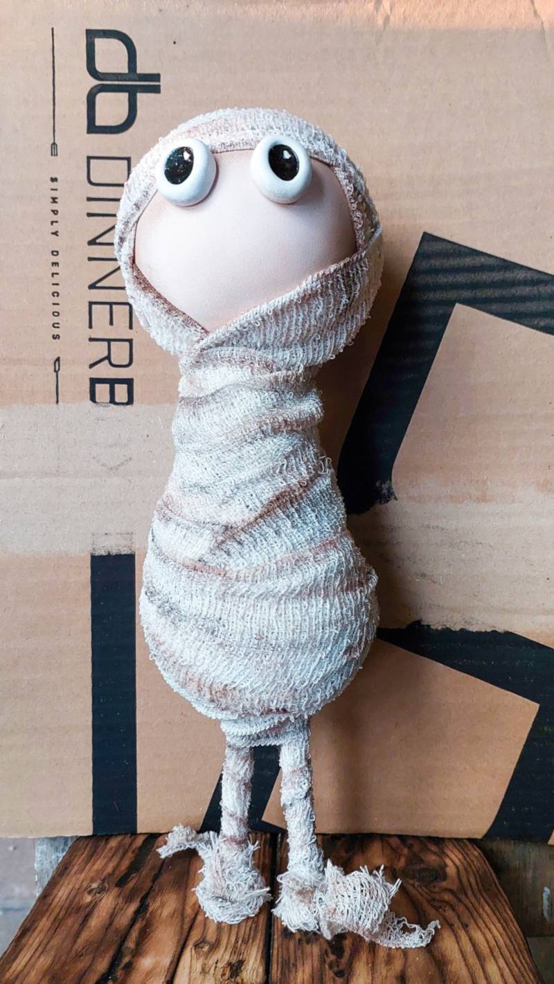 Use the mummy as a guide to cut a sarcophagus shape out of cardboard