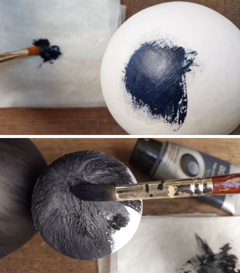 Paint the polystyrene (Styrofoam) balls black