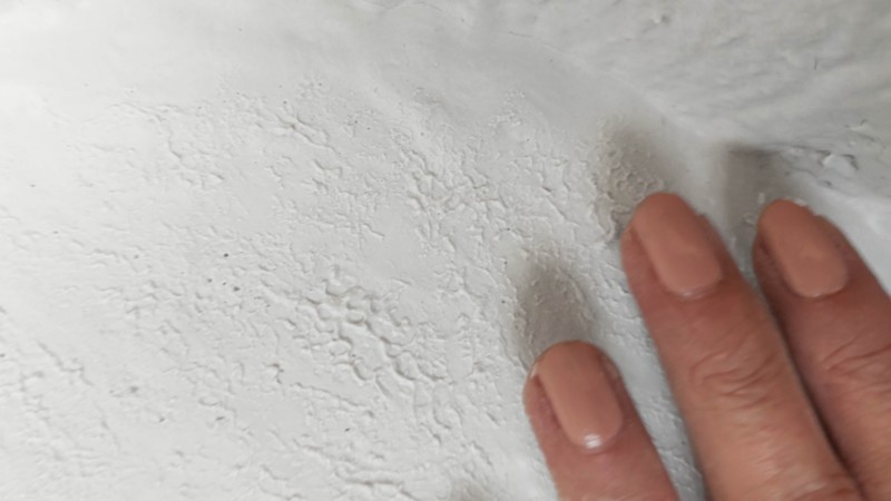 Tap or pat the Plaster of Paris to create a pitted texture