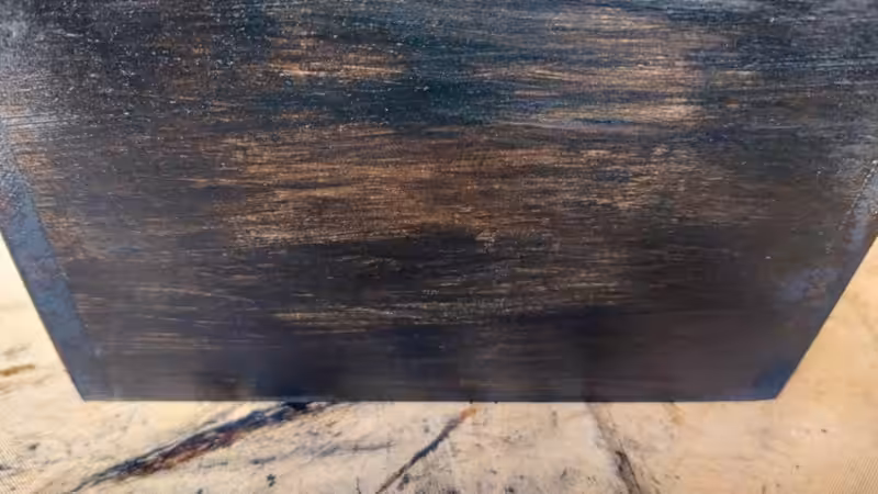A close up of a wooden planter that has been stained a rich, dark brown and sealed with polywax.