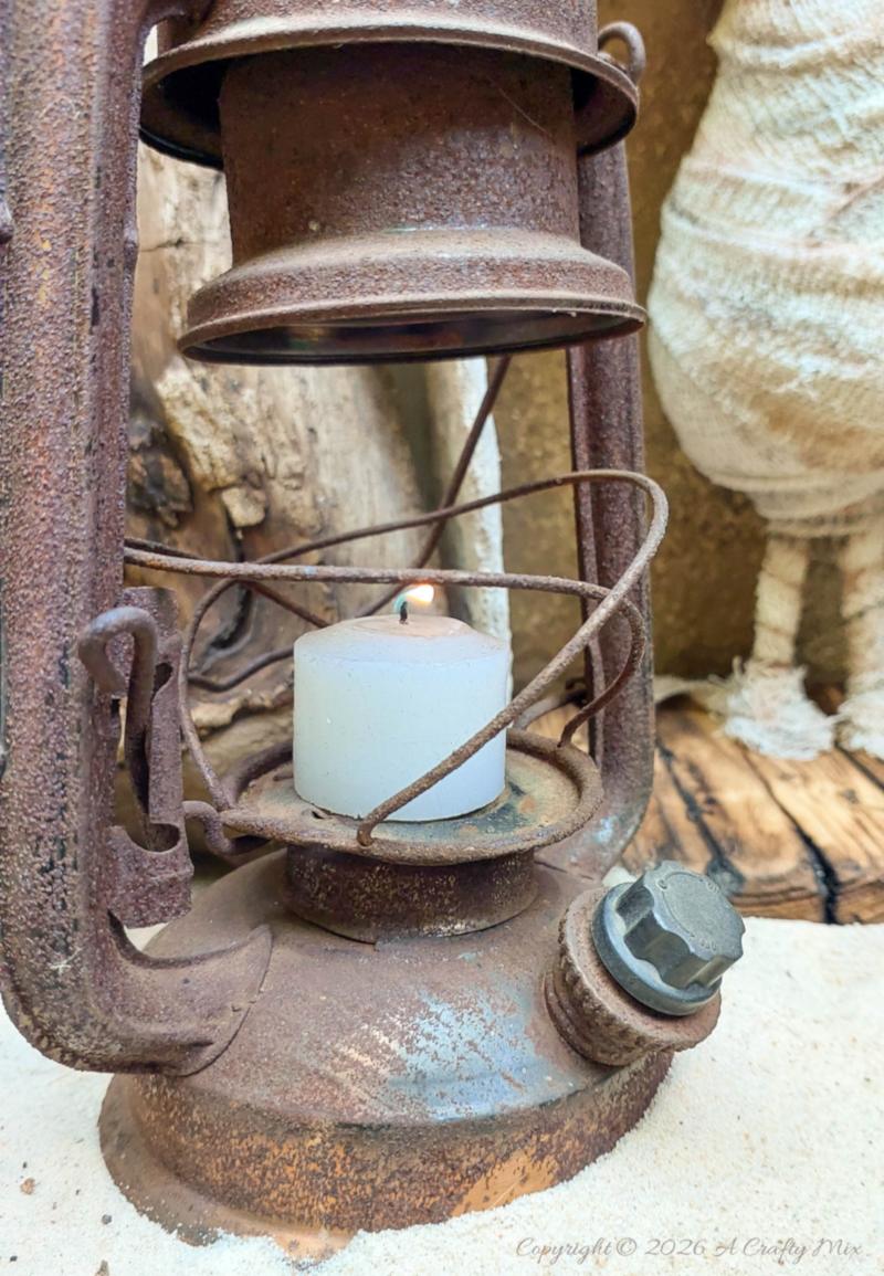 Add a rusty lantern to complete the Halloween vignette.