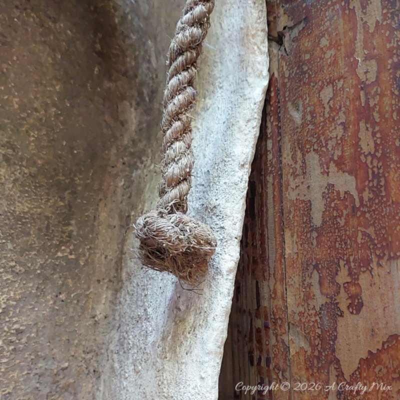 A side view of the sarcophagus with a tatty rope hanging down the side