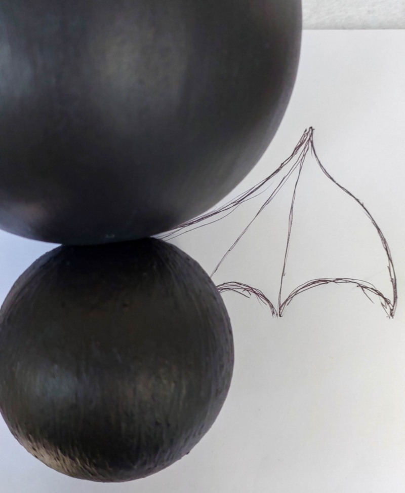Use the bat's body to draw a wing shape