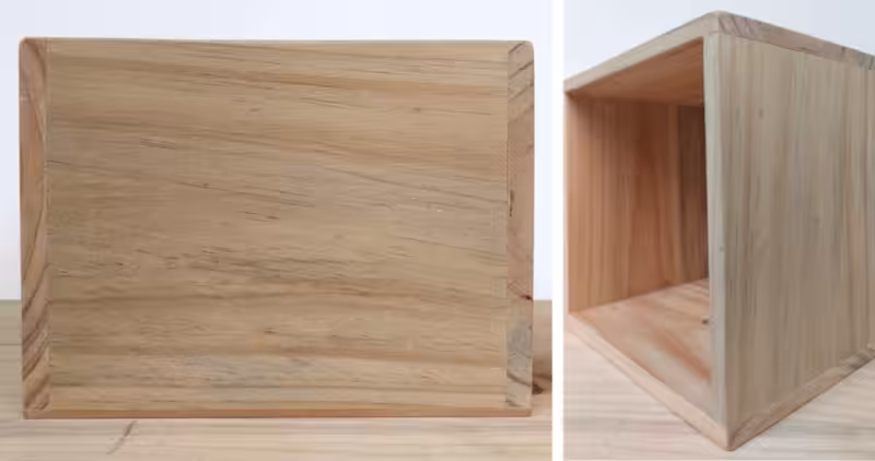 A side view of a square wooden box.