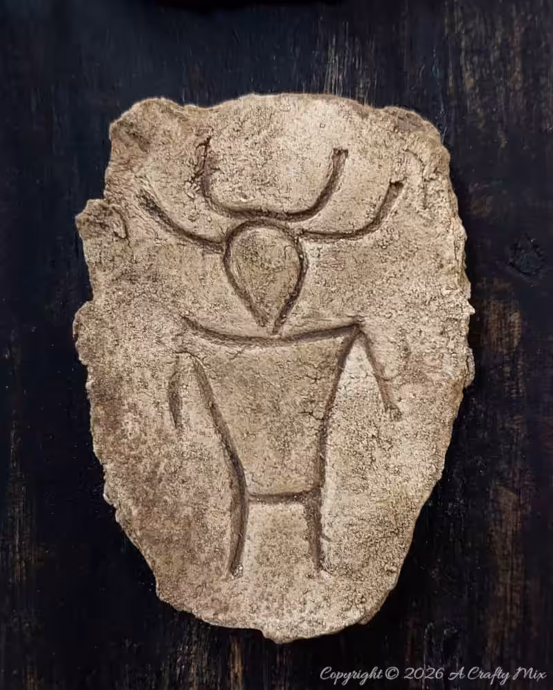 Textured faux stone petroglyph-inspired plaque made with cardboard and clay