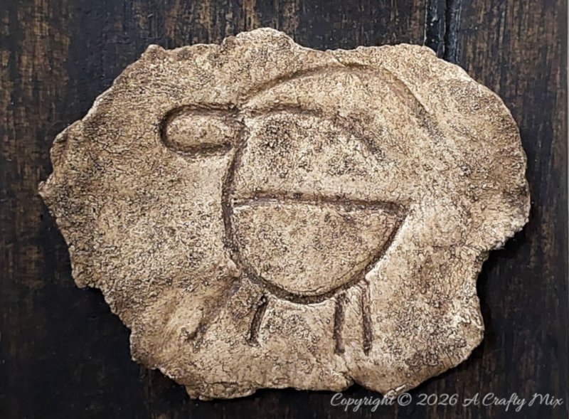 Handmade faux stone petroglyph-inspired plaque with a simple deer symbol