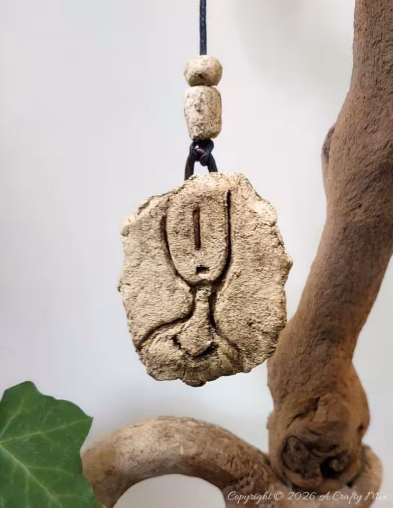 DIY faux stone petroglyph hanging with cord and handmade beads