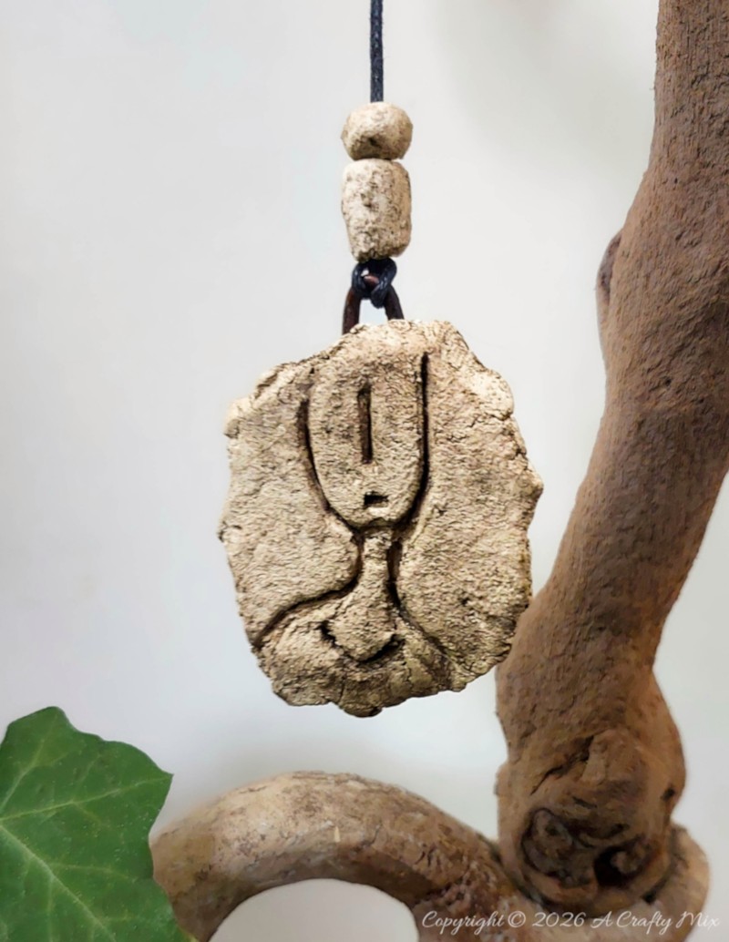 DIY faux stone petroglyph hanging with cord and handmade beads