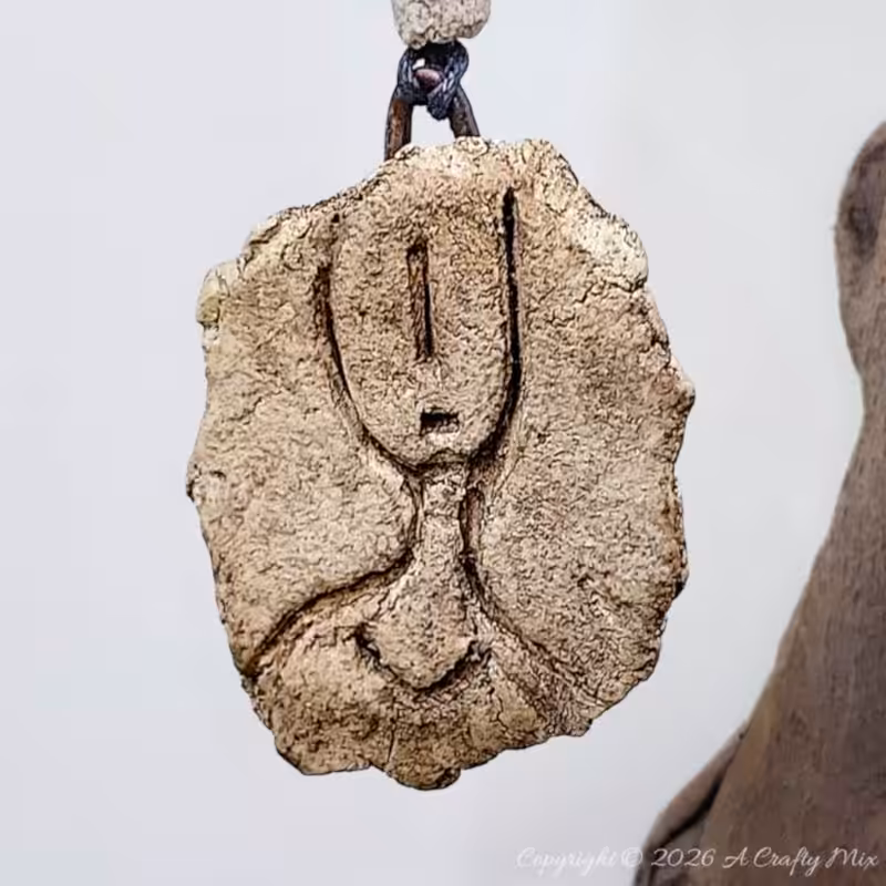 Handmade faux stone petroglyph hanging ornament with clay beads.