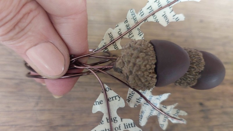 Join the clay acorns and book page leaves to the wire coil