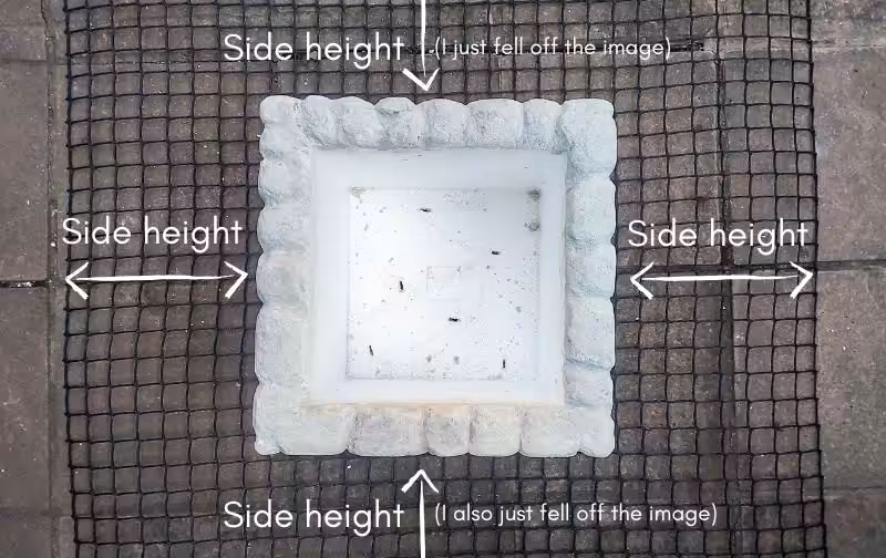 A white cooler sits on top of a wire mesh with measuring instructions on the sides
