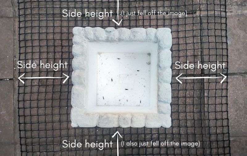 A white cooler sits on top of a wire mesh with measuring instructions on the sides